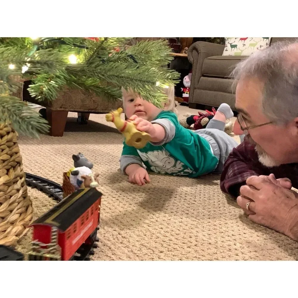 BainGesk Christmas Electric Train Set With Steam Light And Sounds Under The Tree